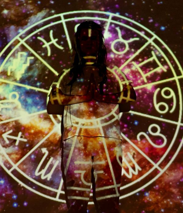 Person in a meditative pose, finding balance and harmony. Neon teal light outlines their silhouette.